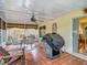 Cozy lanai with tiled floors, roll down shades, a ceiling fan, a dining table, and grill at 1432 Windjammer Pl, Valrico, FL 33594