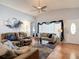 Spacious living room featuring comfortable sofas, a ceiling fan, and natural light from large windows at 1432 Windjammer Pl, Valrico, FL 33594