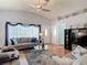 Cozy living room with plush sofas, a ceiling fan, and an entry door with decorative window at 1432 Windjammer Pl, Valrico, FL 33594
