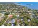 Wide aerial view of a neighborhood with trees and waterways in the distance at 1709 Sunset Dr, Tarpon Springs, FL 34689