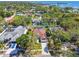 This aerial view showcases the home's prime location amidst lush greenery, creating a serene and private setting at 1709 Sunset Dr, Tarpon Springs, FL 34689