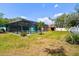 This spacious backyard, featuring a screened-in pool and well-maintained lawn, is perfect for relaxation at 1709 Sunset Dr, Tarpon Springs, FL 34689