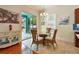 Cozy dining area features wicker furniture and sliding doors to the screened-in lanai and pool at 1709 Sunset Dr, Tarpon Springs, FL 34689