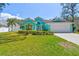 Charming home with a well-manicured lawn, lush landscaping, and a bright, inviting exterior at 1709 Sunset Dr, Tarpon Springs, FL 34689