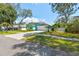 Inviting home with fresh, appealing landscaping, a lush lawn, and a pristine driveway at 1709 Sunset Dr, Tarpon Springs, FL 34689