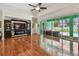 Bright open living room with wood floors and sliding door access to screened lanai and pool at 1709 Sunset Dr, Tarpon Springs, FL 34689
