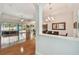 Spacious living area with wood floors, opening to pool area at 1709 Sunset Dr, Tarpon Springs, FL 34689