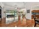 Large living space featuring gleaming hardwood floors, leading to an inviting outdoor pool area at 1709 Sunset Dr, Tarpon Springs, FL 34689