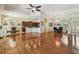 Open-concept living space featuring wood floors, kitchen, and dining areas under a tray ceiling at 1709 Sunset Dr, Tarpon Springs, FL 34689