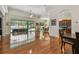 Spacious living room with wood floors and sliding doors to screened lanai with pool at 1709 Sunset Dr, Tarpon Springs, FL 34689