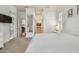 Bright main bedroom features plush carpet, white trim, and an adjacent main bath and closet at 1709 Sunset Dr, Tarpon Springs, FL 34689