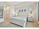 Main bedroom featuring bright neutral walls, a tray ceiling, soft natural lighting, and minimalist decor at 1709 Sunset Dr, Tarpon Springs, FL 34689