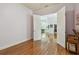 Bright office space with hardwood floors, open doorway, and natural light streaming in from the entryway and kitchen at 1709 Sunset Dr, Tarpon Springs, FL 34689