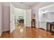 Hardwood-floored office space featuring a vanity, and flooded with natural light from the entryway and dining room at 1709 Sunset Dr, Tarpon Springs, FL 34689
