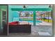 Screened in patio overlooks the sparkling pool and features comfortable outdoor seating and multiple fans at 1709 Sunset Dr, Tarpon Springs, FL 34689