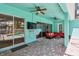 Covered patio with outdoor seating, TV, and easy access to the inviting backyard pool at 1709 Sunset Dr, Tarpon Springs, FL 34689
