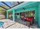 Covered patio featuring outdoor seating with a TV, overlooking the backyard at 1709 Sunset Dr, Tarpon Springs, FL 34689