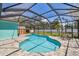 Screened-in pool area showcases a well-maintained backyard with comfortable outdoor seating at 1709 Sunset Dr, Tarpon Springs, FL 34689
