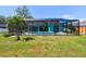 The inviting screened-in pool, nestled within a spacious backyard, offers a perfect oasis for relaxation at 1709 Sunset Dr, Tarpon Springs, FL 34689