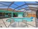 Inviting screened-in pool with a table and chairs creates an ideal outdoor living space at 1709 Sunset Dr, Tarpon Springs, FL 34689