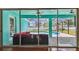 Covered lanai seating area overlooking pool with screened enclosure, great for outdoor relaxation at 1709 Sunset Dr, Tarpon Springs, FL 34689