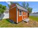 A spacious, orange shed with white trim provides ample backyard storage at 1709 Sunset Dr, Tarpon Springs, FL 34689