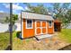Well-maintained shed with double doors offers convenient storage in the backyard at 1709 Sunset Dr, Tarpon Springs, FL 34689