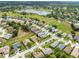 Beautiful aerial view of a well maintained neighborhood with lush landscaping, and a tranquil lake in the background at 18514 Hidden Pines Way, Hudson, FL 34667
