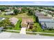 Aerial view of a well-maintained home with a green lawn and landscaping in a peaceful neighborhood at 18514 Hidden Pines Way, Hudson, FL 34667