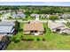 Aerial view of a home with a lush, green lawn and manicured landscaping in a well-maintained neighborhood at 18514 Hidden Pines Way, Hudson, FL 34667
