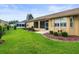 The backyard features a screened lanai, lush green lawn, and tidy landscaping with well-maintained plants at 18514 Hidden Pines Way, Hudson, FL 34667