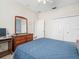 Well-lit bedroom featuring a dresser and mirror, a closet, and an ensuite bathroom at 18514 Hidden Pines Way, Hudson, FL 34667