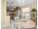 Spacious breakfast nook with table, open to the kitchen, with bright light and modern finishes at 18514 Hidden Pines Way, Hudson, FL 34667