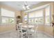 Sunny breakfast nook with white chairs, bright windows, and neutral paint at 18514 Hidden Pines Way, Hudson, FL 34667