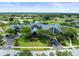 Aerial view of a grand clubhouse with meticulously manicured grounds and golf course in a serene neighborhood at 18514 Hidden Pines Way, Hudson, FL 34667