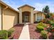 Inviting front entrance with meticulous landscaping and a brick-accented walkway at 18514 Hidden Pines Way, Hudson, FL 34667