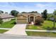 Charming single-story home with a two-car garage, well-manicured lawn, and mature landscaping at 18514 Hidden Pines Way, Hudson, FL 34667