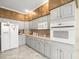 Updated kitchen with white appliances, ample counter space, and stylish cabinets at 18514 Hidden Pines Way, Hudson, FL 34667