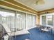 Outdoor lanai with plenty of furniture for entertaining and views of the yard and surrounding area at 18514 Hidden Pines Way, Hudson, FL 34667