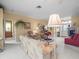 Cozy living room with comfortable seating, floral accents, and well-maintained carpet at 18514 Hidden Pines Way, Hudson, FL 34667