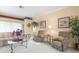 Comfortable living room with decorative accents, plush chairs, and great natural light at 18514 Hidden Pines Way, Hudson, FL 34667