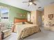 Large main bedroom featuring a ceiling fan, neutral carpet, and views to the outside at 18514 Hidden Pines Way, Hudson, FL 34667