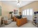 Comfortable home office space with natural light, a ceiling fan and contemporary furnishings at 18514 Hidden Pines Way, Hudson, FL 34667