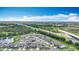 Aerial view showcasing a pond-side neighborhood close to the highway, offering convenience and scenic beauty under a blue sky at 1876 Colding Dr, Ruskin, FL 33570