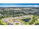 Aerial shot features homes near a pond and a roundabout, blending community living with scenic nature views under a clear sky at 1876 Colding Dr, Ruskin, FL 33570