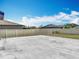 Large concrete backyard with white fence, offering ample space for outdoor activities and privacy at 1876 Colding Dr, Ruskin, FL 33570