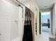 Bathroom shower featuring a shower curtain, white tiles, and neutral color scheme at 1876 Colding Dr, Ruskin, FL 33570