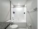 This bright bathroom features a white shower-tub combination and neutral color scheme at 1876 Colding Dr, Ruskin, FL 33570