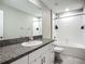 Bright bathroom with white cabinets, granite countertops, and a shower-tub combination at 1876 Colding Dr, Ruskin, FL 33570