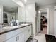 Bathroom with double vanity, granite countertops, and an adjacent walk in closet at 1876 Colding Dr, Ruskin, FL 33570